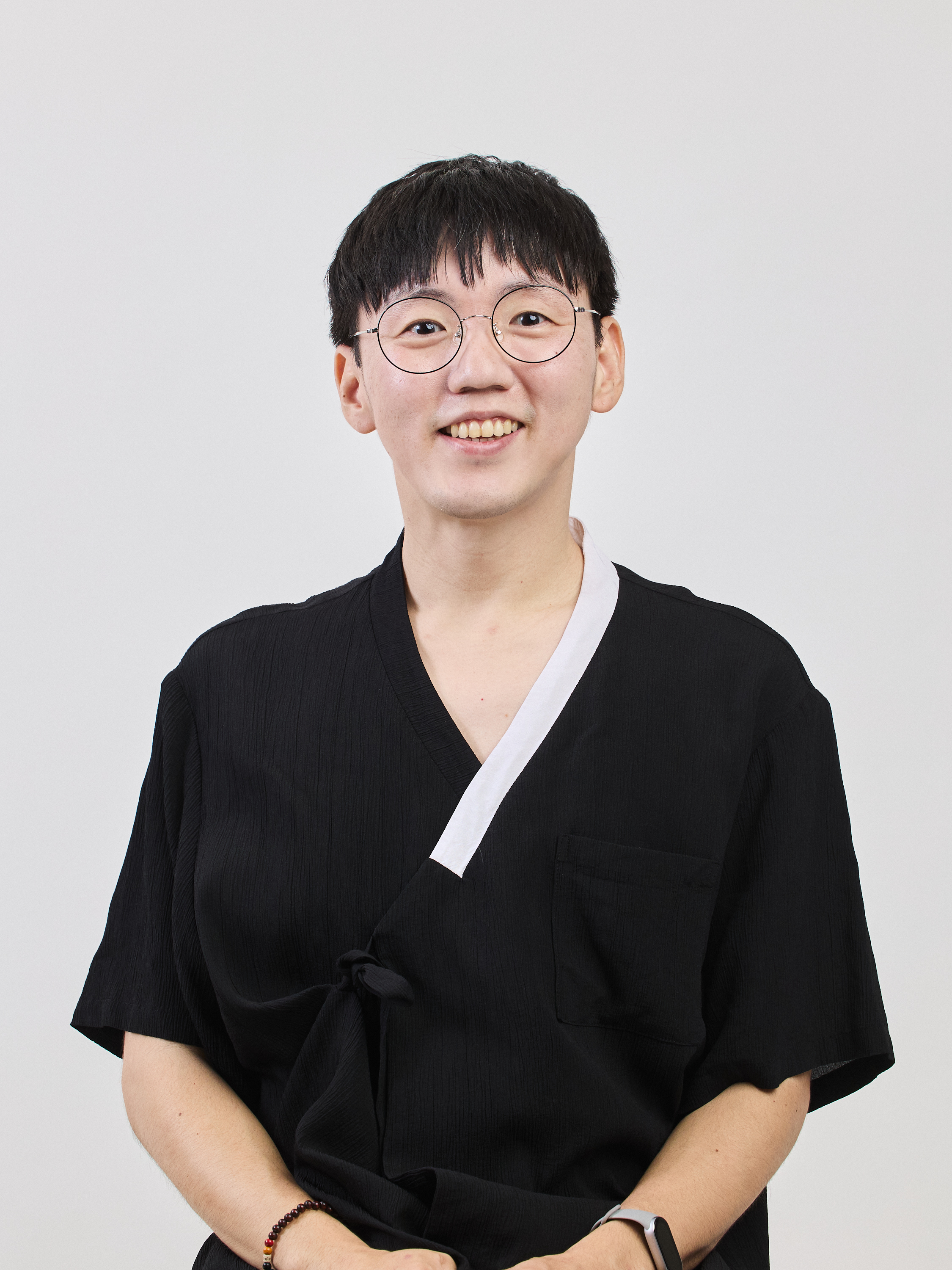 Billy Seol wearing a traditional Korean hanbok, smiling